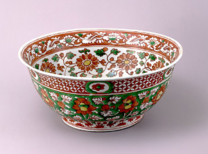 Bowl with floral scroll design in overglaze enamels.