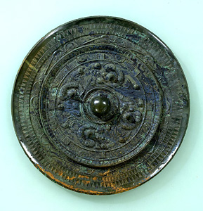 Bronze mirror with design of divinities and dragons.