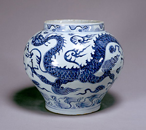 Jar with dragon and wave design in underglaze blue.