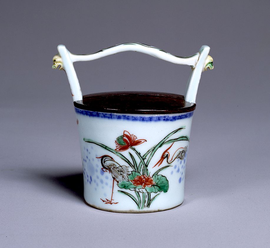 Tea caddy in shape of bucket with handle.