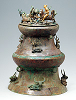 Bronze cowry-container decorated with a hunting scene  