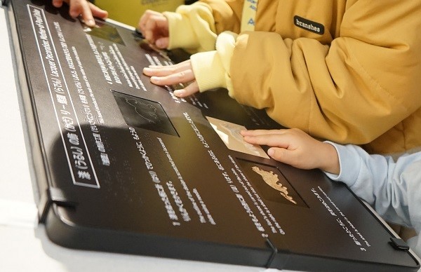 本館19室で漆の触察ボードを体験するイメージ画像