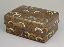 Tebako (cosmetic box), design of viii wheels
            half-submerged in stream in maki-e lacquer and mother-of-pearl inlay