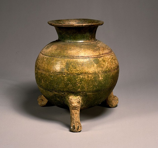 Image of "Green glazed jar with three legs."