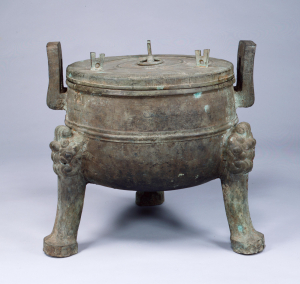 Image of "Tripod cauldron ding with coiling dragon design."