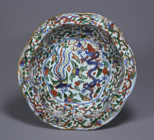 Image of "Six lobed bowl with everted flat rim with design of dragons and phoenixes in overglaze enamels."