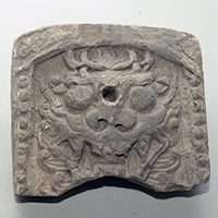 Image of "Ridge-end Tile, Demon face design, Excavated at former site of Sacheonwangsa temple, Gyeongju, Korea, Unified Silla dynasty, 7th-8th century"