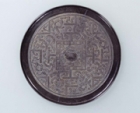 Image of "Bronze Mirror, with design of TLV pattern and coiling snakes, China, Western Han dynasty, 2nd century BC 	"